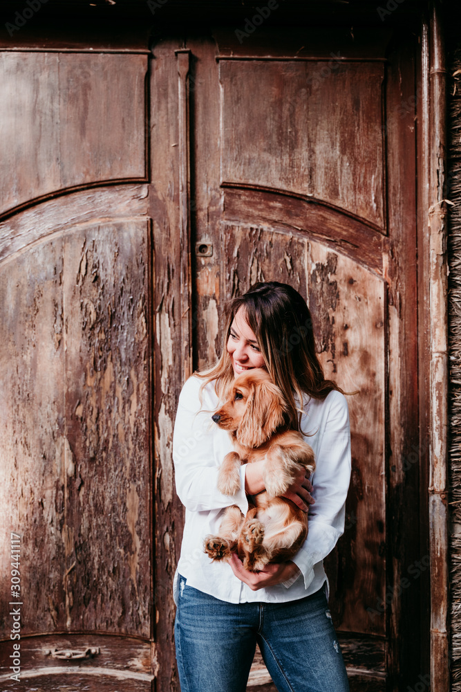 young woman and her cute puppy of cocker spaniel outdoors young woman and her cute puppy of cocker spaniel outdoors