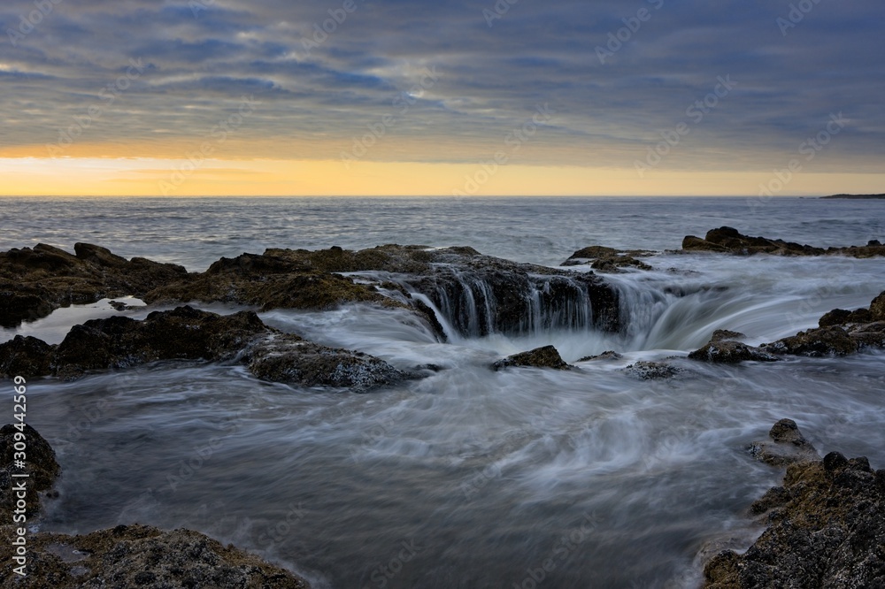 Water flowing into Thor's Well during dramatic sunset Cape Perpetua Oregon Coast