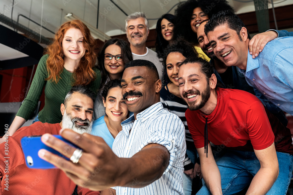 © Santi Nunez/Stocksy - Business people taking selfie