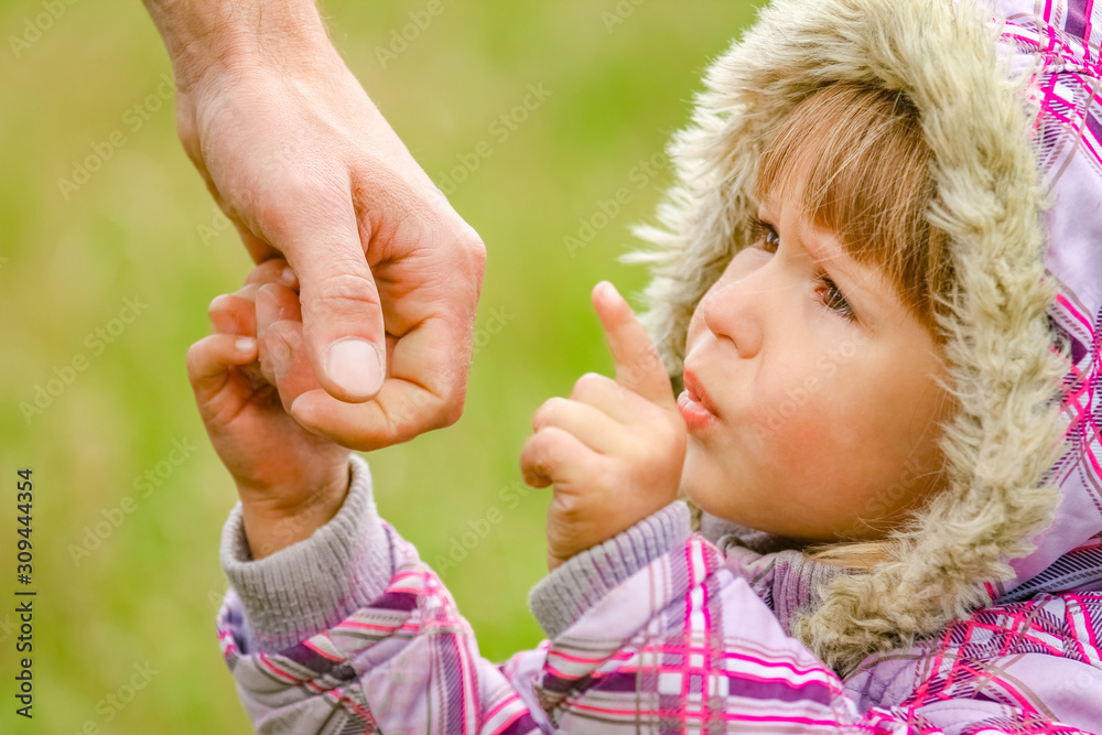 hands Happy parents and child outdoors in the park