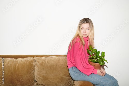 Upset casual girl with flowerpot