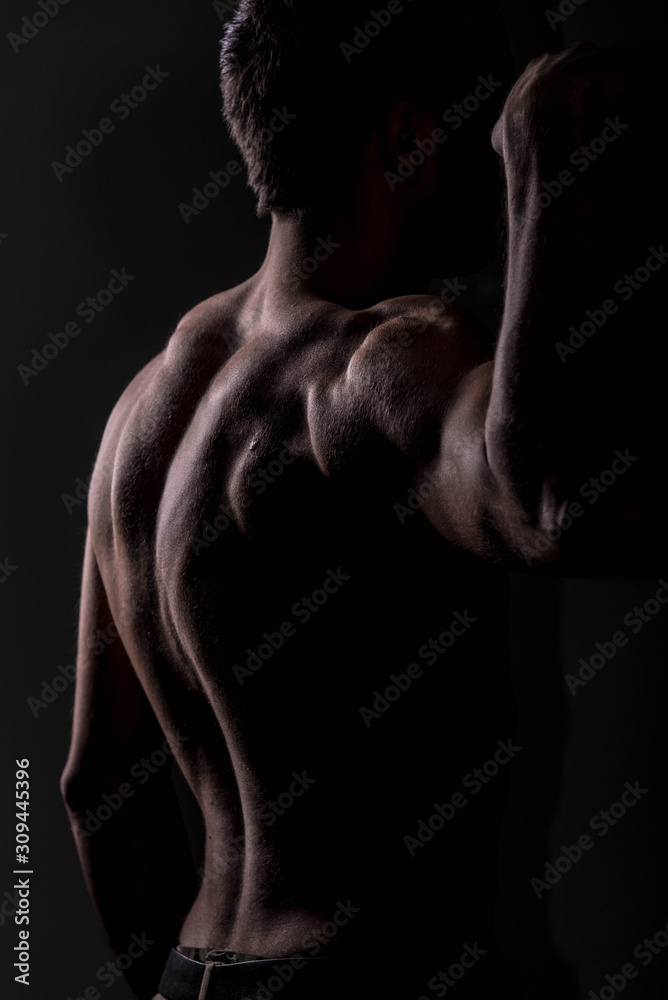 Strong athletic man on black background, Fitness shaped muscle man posing Strong athletic man on black background, Fitness shaped muscle man posing