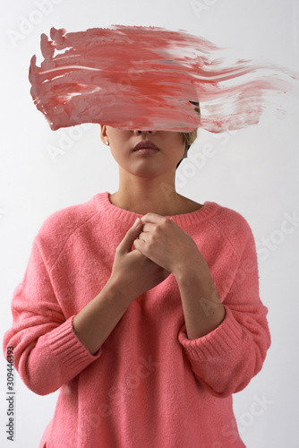 Contemporary model with paint smear covering face