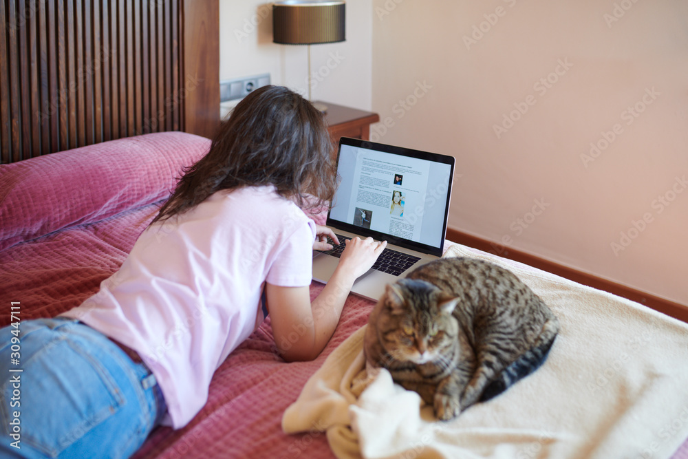 Woman with cat chilling on bed Woman with cat chilling on bed