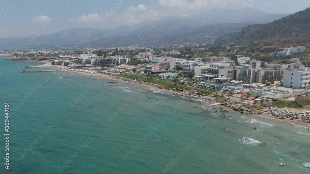 Aerial panorama on beach and blue sea. People swim, enjoy life and summer holidays, Crete, Greece Aerial panorama on beach and blue sea. People swim, enjoy life and summer holidays, Crete, Greece