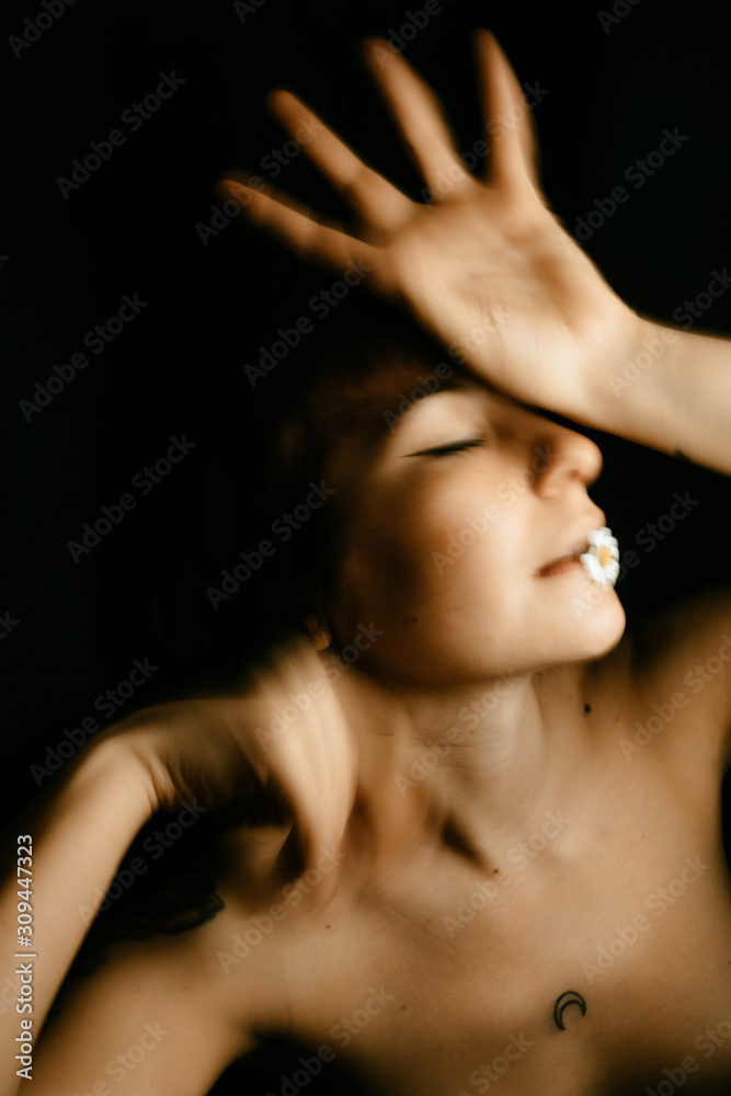 portraits of woman with small daisy in motion portraits of woman with small daisy in motion