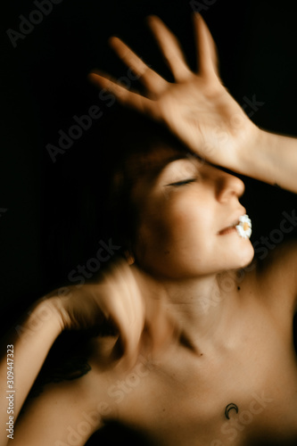 portraits of woman with small daisy in motion
