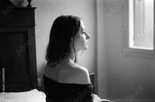 A beautiful film portrait of a woman in a bedroom