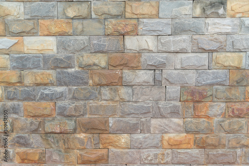 The texture of the wall is made of smooth stone blocks