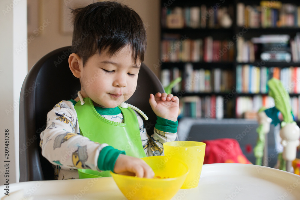 Little kid eating in high chair Little kid eating in high chair