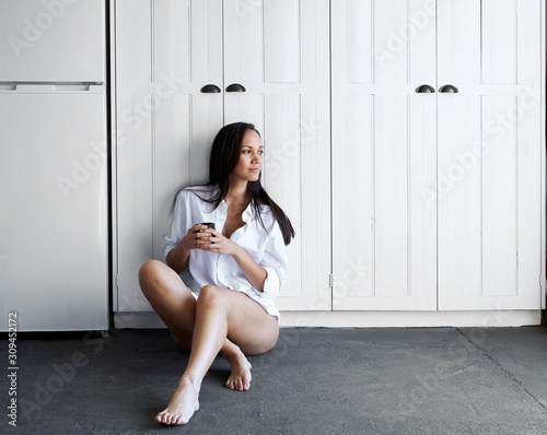 woman leaning against cupboards