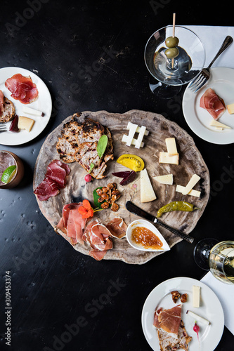 Charcuterie plate on wooden platte with drinks