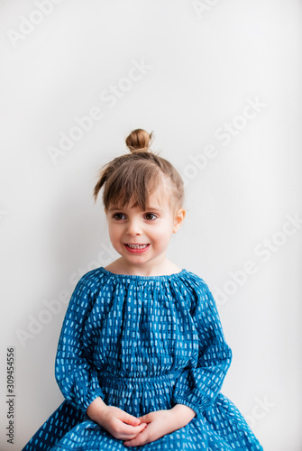 Three year old girl, sitting politely photo