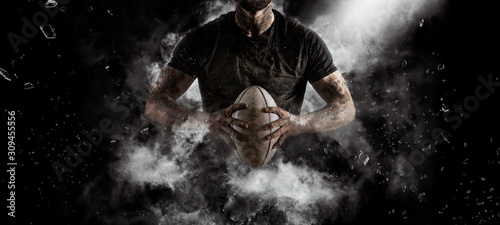 Rugby player in action on dark photo