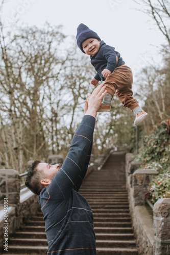 Father Playing with Child Tossing them in the Air photo