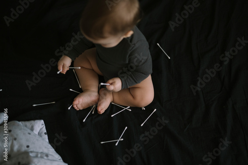 Baby Playing With Cotton Swabs photo