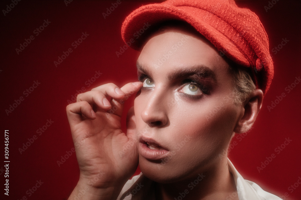 Young man with makeup in hat Young man with makeup in hat