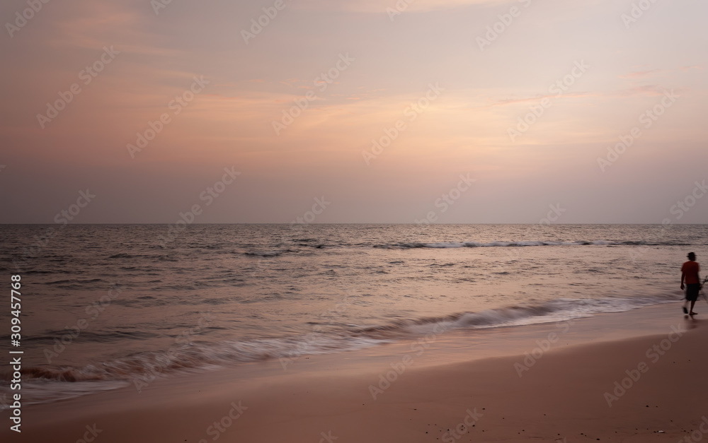 Susnet at Anjuna beach goa with a man on the beach