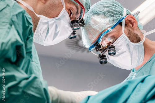 Doctors in masks with professional magnifying glasses photo