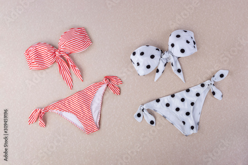 red and white striped sita bikini and black and white polka dot bikini isolated on textured background