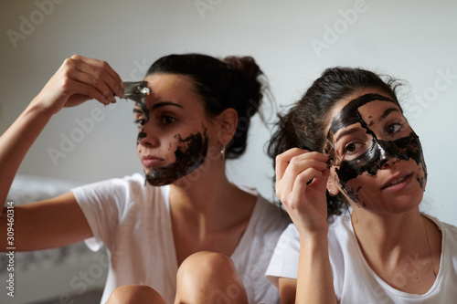 Pretty girls removing black mask photo