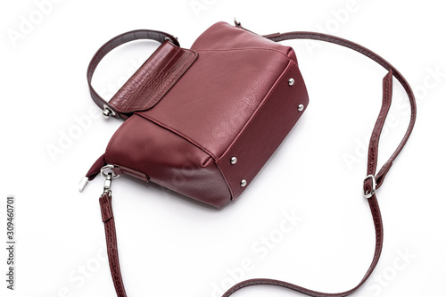 Luxury fashion women leather wine handbag isolated on a white background.