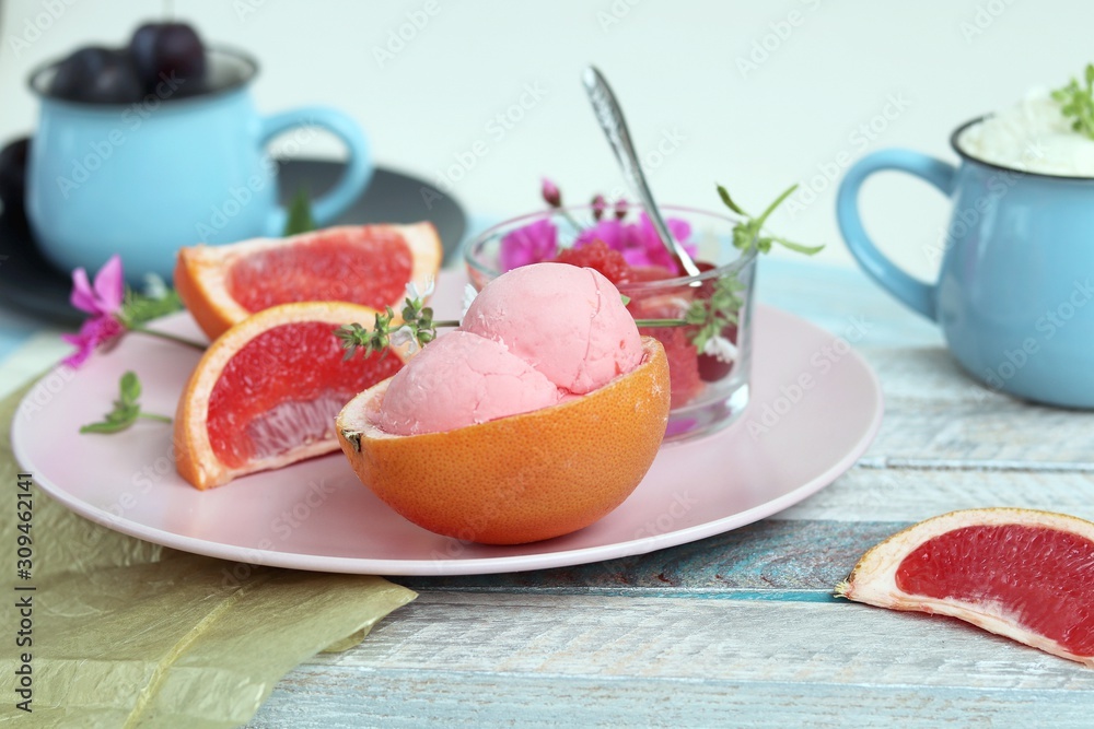 Natural ice cream, grapefruit, basil on a wooden table, tasty and healthy dessert, seasonal food Natural ice cream, grapefruit, basil on a wooden table, tasty and healthy dessert, seasonal food