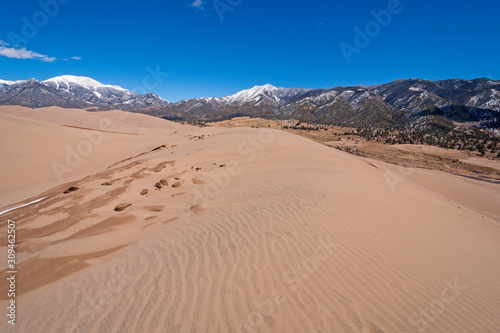 Sand Dunes Amidst the Snowy Mountains