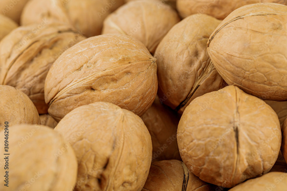 Raw walnuts, close-up, background with walnuts. Raw walnuts, close-up, background with walnuts.
