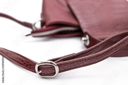 Luxury fashion women leather wine handbag isolated on a white background.