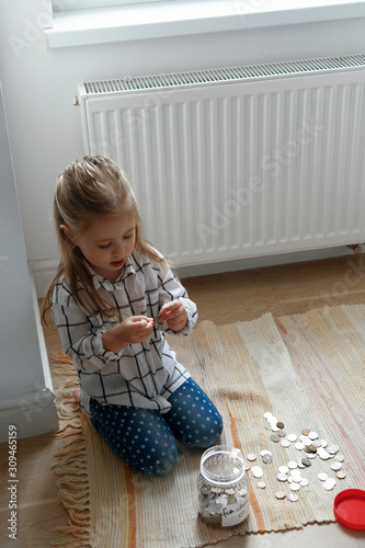 Girl sitting with saved money