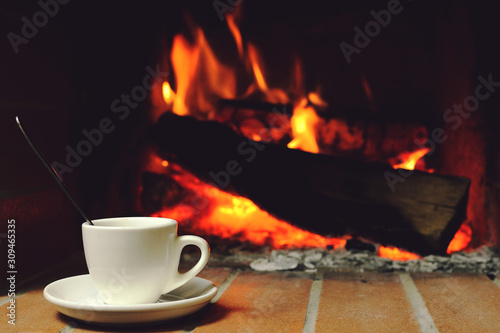 A Cup of hot coffee by fireplace