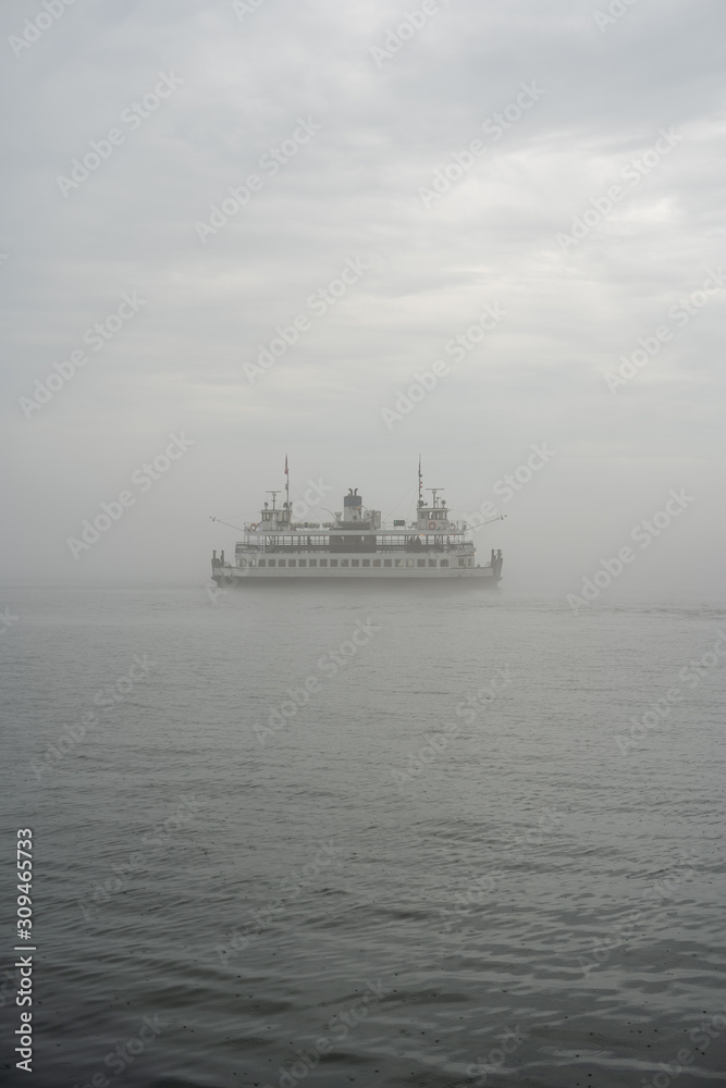 ferry on a lake in fog