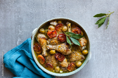 Chicken tagine with apricots, green olives and bay leaves photo