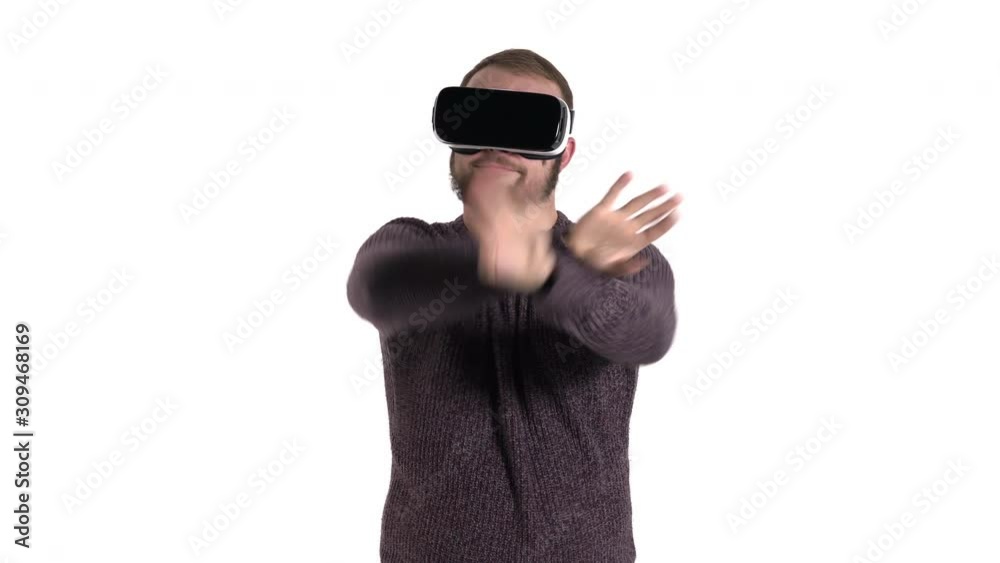 Close-up demonstration of a young bearded man dancing in funny manner while using VR glasses. Cool high tech devices usage concept Close-up demonstration of a young bearded man dancing in funny manner while using VR glasses. Cool high tech devices usage concept