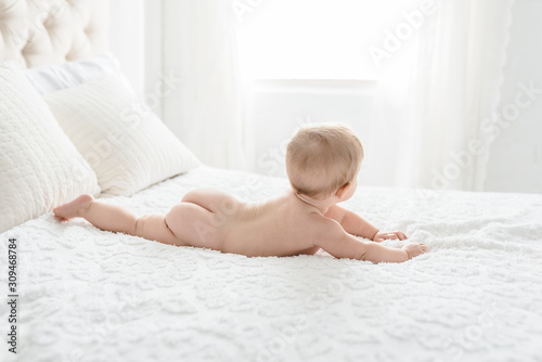 A Little Baby's Bottom On A Simple Bed