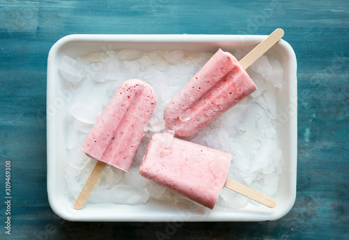 Three strawberry popsicles in a ice tray photo