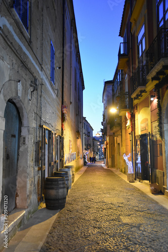 Fototapeta Naklejka Na Ścianę i Meble -  Caiazzo, Italy, 11/12/2019. A narrow street among the old houses of a medieval village