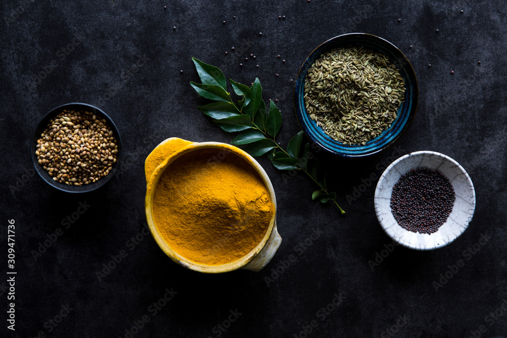 Cooking spices in bowls with curry leaf Cooking spices in bowls with curry leaf