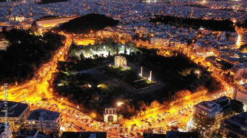 Aerial drone photo of iconic ruins of Temple of Zeus in Athens historic centre at dusk with beautiful sky and colours and Syggrou avenue at the background, Attica, Greece