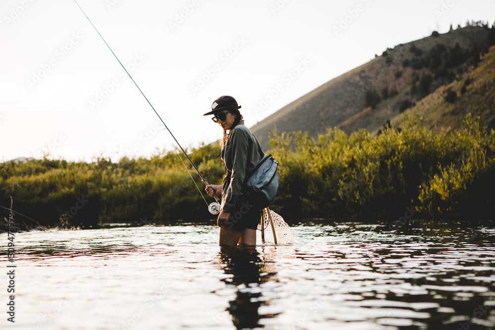 Woman Fly Fishing a Small Stream Woman Fly Fishing a Small Stream