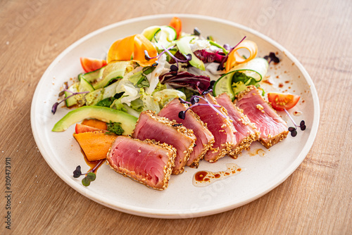 tuna steak with fresh salad on teh wooden background