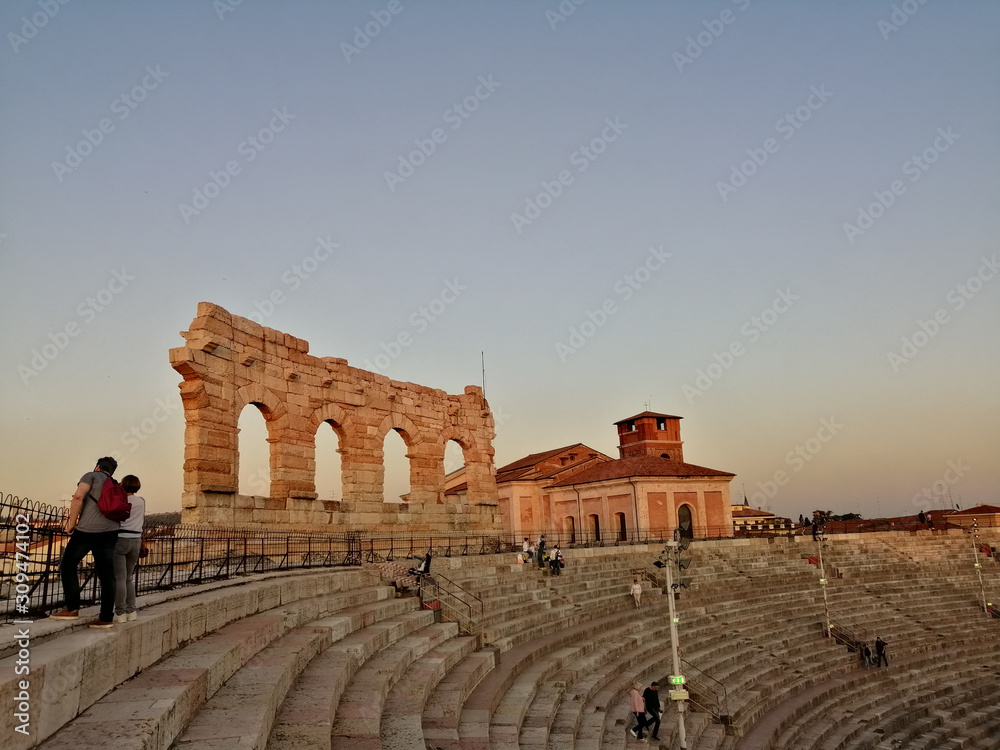Internal staircase of the Arena di Verona overlooking the city at sunset.