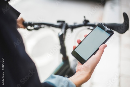 Cropped image of food delivery woman with map on smart phone photo