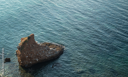 A small piece of land at sea. A piece of rock reminiscent of the foot.