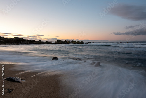 Landscape of a rocky beach with cloudy sky, silk effect, long exposure in Cangas, O Grove, Aldán, Vigo, Pontevedra, Galicia, Spain.