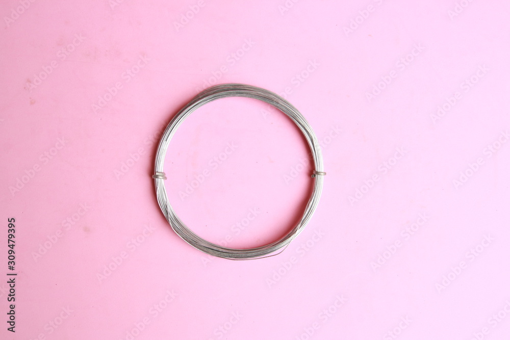 roll of metal wire of hardware store on colored background roll of metal wire of hardware store on colored background