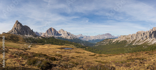 The Giau Pass in the Italian Dolomites in beautiful weather with white clouds in the blue sky.