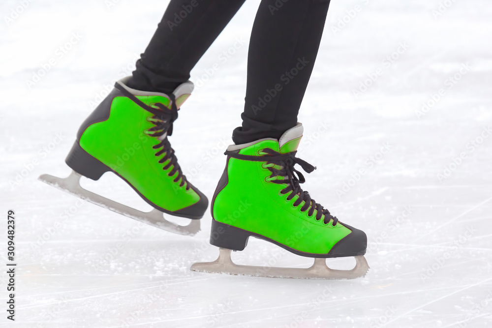 legs of a girl ice skating on an ice rink. Hobbies and sports. Vacations and winter activities legs of a girl ice skating on an ice rink. Hobbies and sports. Vacations and winter activities