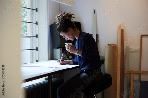 Side view of architect working in office photo